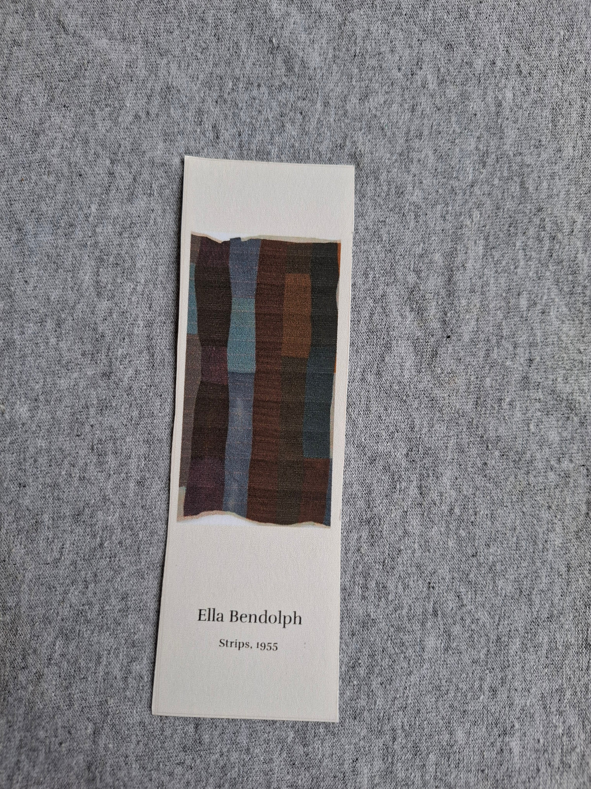 Front of heritage bookmark featuring Gran Ella Bendolph's Strips quilt (1955), with dark vertical fabric strips.