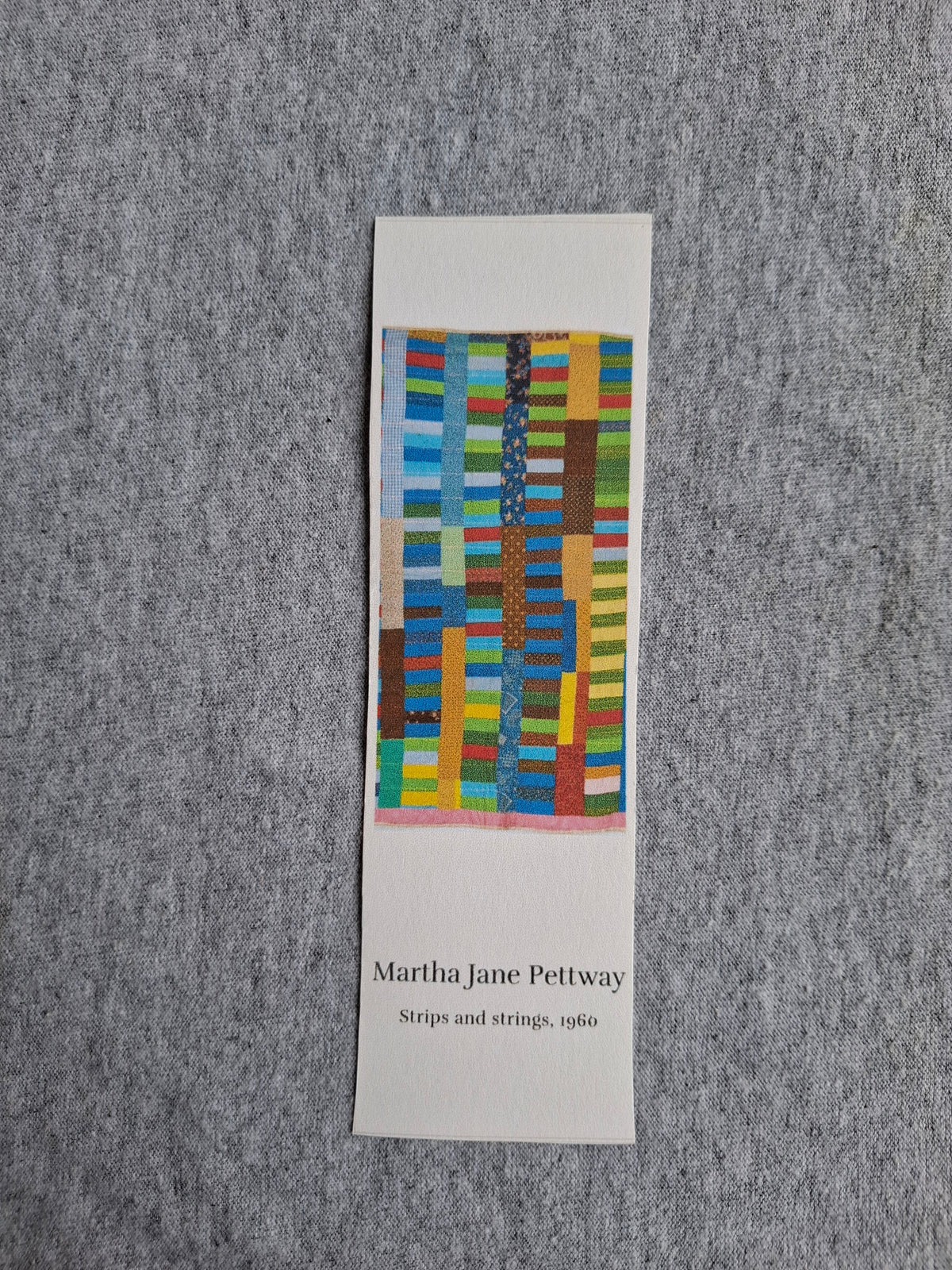 Front of heritage bookmark featuring Grandma Martha Jane Pettway's colorful Strips and Strings quilt (1960).