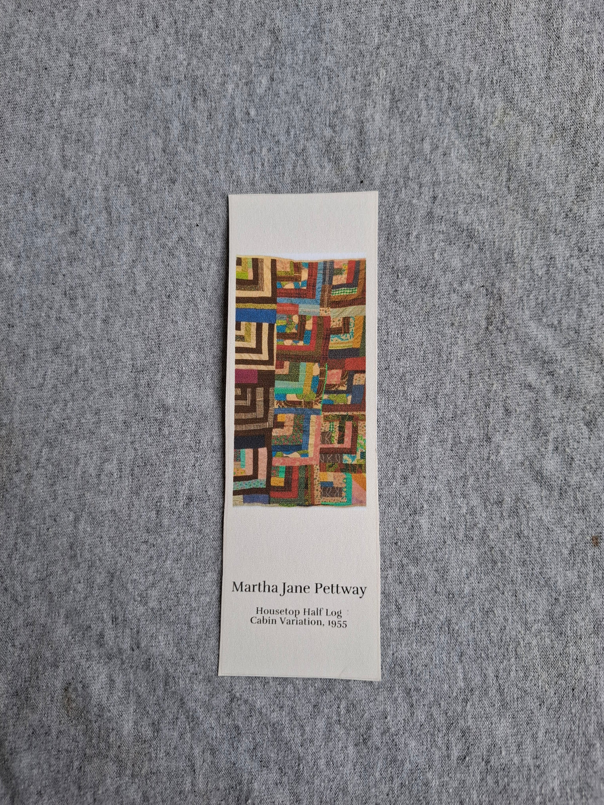 Front of heritage bookmark featuring Grandma Martha Jane Pettway's Housetop Half Log Cabin Variation quilt (1955), with colorful geometric blocks.
